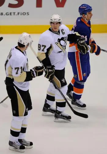 Evgeni Malkin (left) and Sidney Crosby (right) haven&lsquo;t had to be superstars for the Penguins to do well this year.  (Paul Bereswill/Getty Images)