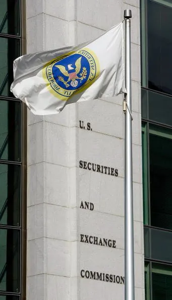 A flag flies in front of the U.S. Securities and Exchange Commission building in Washington, DC. Peter Siris, a stock promoter, has recently been charged with securities law violations by the SEC.  (Chip Somodevilla/Getty Images) 
