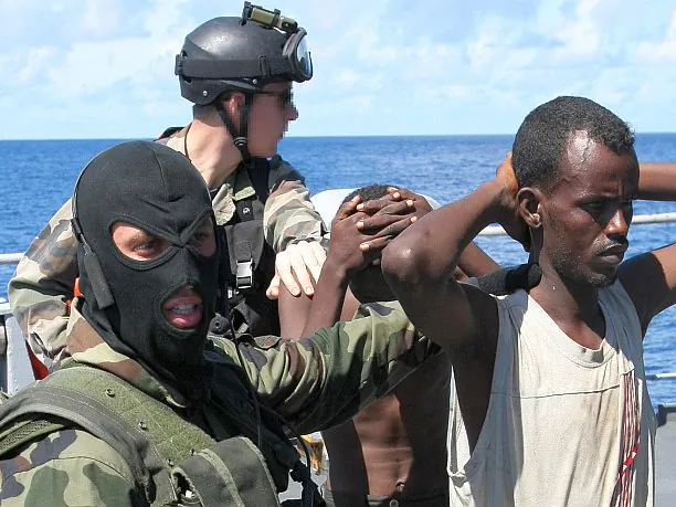 French soldiers guard suspected Somali pirates on board the French warship Le Nivose, after their capture on May 3, 2009, as part of EU's Atalante anti-piracy naval mission. The number of ships signaling attacks by Somali pirates has fallen this year to its lowest since 2009, a report from the International Chamber of Commerce International Maritime Bureau (IMB) revealed, but IMB warns seafarers need to remain vigilant in high-risk waters around Somalia, the Gulf of Aden, and the Red Sea. Meanwhile, violent attacks and hijackings are spreading in the Gulf of Guinea. (Pierre Verdy/AFP/Getty Images)