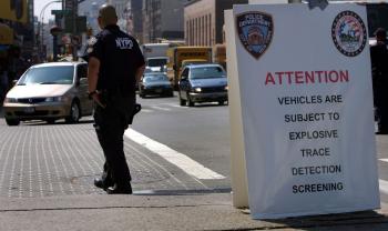 A police officer looks out for trucks to call in for inspection on June 5, 2007 in New York City. The New York Police Department (NYPD) set up a morning inspection station called 'Rolling Vigilance' to inspect area trucks with a radiation scanner. (Spencer Platt/Getty Images)