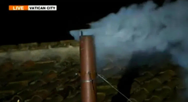 The white smoke rises from the Sistine Chapel chimney in a screenshot of an Al Jazeera live broadcast from the Vatican, signaling that a new pope has been chosen.