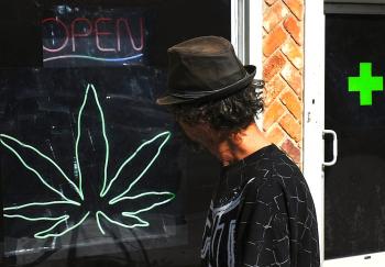 GOING TO POT: A man walks past a medicinal marijuana dispensary in Los Angeles, Calif. Marijuana use and availability is on the rise with Americans, according to survey data released by the Substance Abuse and Mental Health Services Administration (SAMHSA (Mark Ralston/Getty Images)