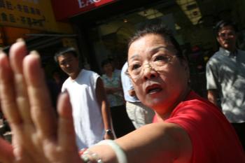 OUTSPOKEN: A woman is caught on camera after verbally attacking two individuals for supporting Falun Gong. (Marcus Gayle/The Epoch Times)