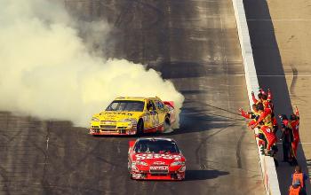 Clint Bowyer does his victory doughnut as Tony Stewart coasts towards the finish line, dropping from 1st to 24th. (Elsa/Getty Images) Clint Bowyer does his victory doughnut as Tony Stewart coasts towards the finish line, dropping from 1st to 24th. (Elsa/Getty Images)