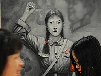 Two Chinese women walk past a painting of a Red Guard from China's Cultural Revolution period at an art exhibit in Shanghai on April 17, 2008. (Mark Ralston/AFP/Getty Images)