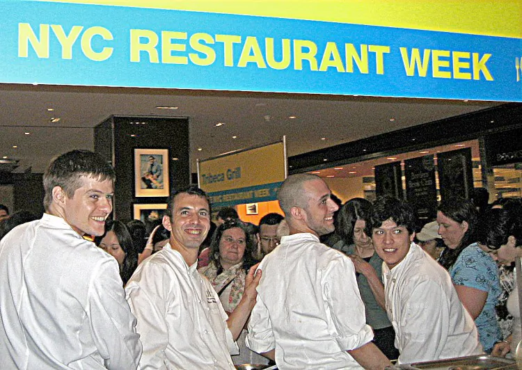 Chef Olivier Muller (2nd from the left) and his staff smile for the camera at a previous New York City Restaurant Week kickoff. (Vicky Zheng/The Epoch Times )