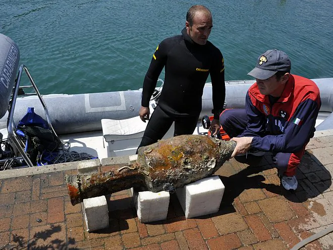 The Carabinieri dive team of Liguria examine a recovered amphora, or storage jar, found at the site of a 2,000-year-old Roman shipwreck off the coast of Italy near Genoa. (Carabinieri Diving Center of Liguria)
