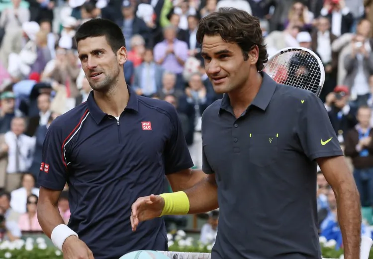 Novak Djokovic (L) bested Roger Federer in their last Grand Slam meeting, the semi-finals of the 2012 French Open. (Jacques Demarthon/AFP/GettyImages)