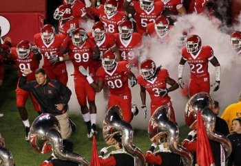 In this file photo, head coach Greg Schiano of the Rutgers Scarlet Knights leads his team onto the field to play against the Connecticut Huskies. Rutgers's player Eric LeGrand was injured and paralyzed after a tackle during a weekend game against Army. (Jim McIsaac/Getty Images)