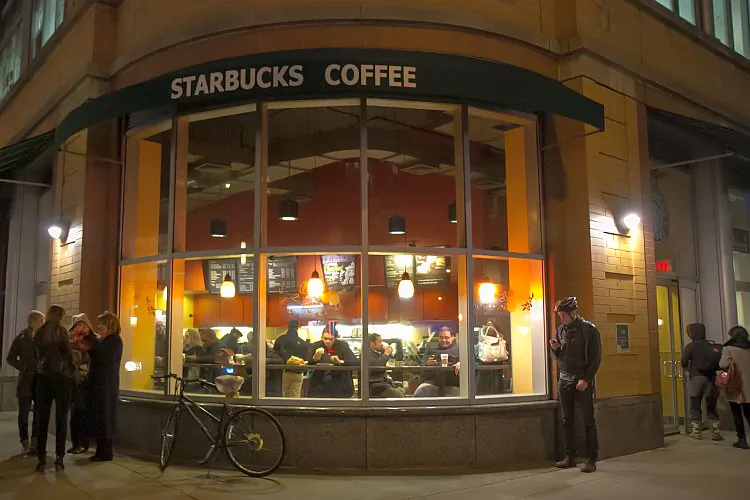 A busy Starbucks in Midtown Manhattan on Feb 2. The National Gun Victims Action Council called on its supporters to stop buying Starbucks products from Feb. 14, until the open gun policy is changed. (Benjamin Chasteen/The Epoch Times)