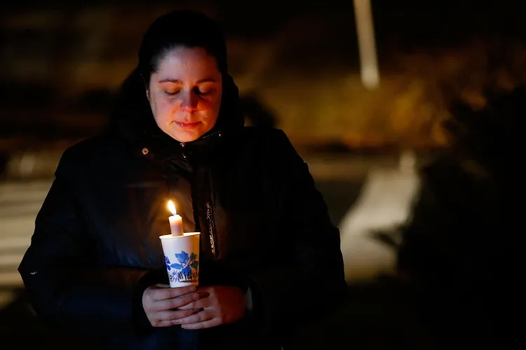 A mourner cries while visiting a memorial, Dec. 15, 2012, in honor of the victims of the Sandy Hook Elementary School shooting in Newtown, Conn. As the nation mourns the tragedy, experts say that we should be careful with how the event shapes national policy. (Jared Wickerham/Getty Images)