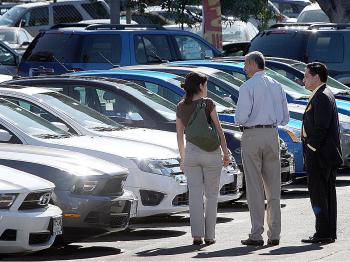 Customers shop for cars at a dealership in Glendale, California. (David McNew/Getty Image)