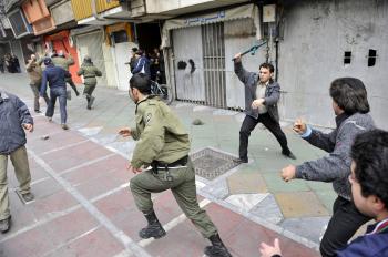 Iranian opposition protesters clash with security forces in Tehran on December 27, 2009.  (AFP/Getty Images)