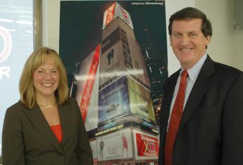 WALGREENS RETURNS: Kim Feil and Craig Sinclair pose in front of a rendering of what their new giant LED sign will look like at night in the heart of Times Square. (Jonathan Weeks/Epoch Times)