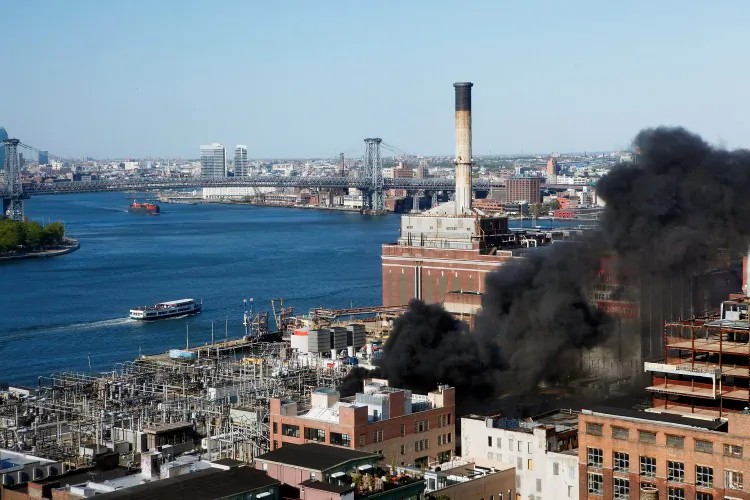 Smoke rises from a Con Edison power plant after a small explosion and fire broke out in DUMBO, Brooklyn, on Sunday. Residents reported hearing an explosion and felt homes shaking. No injuries were reported. (Beth A. Keiser/Getty Images)