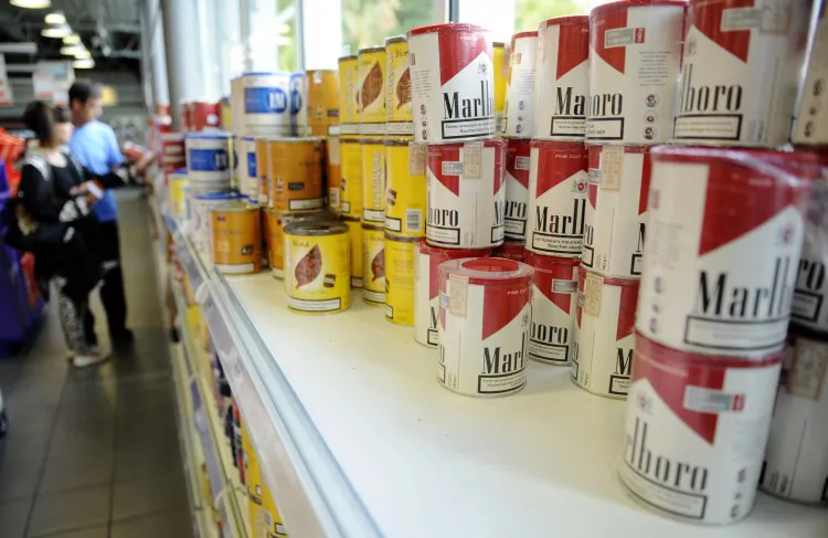 Customers purchase cigarettes in a service-station in Berchem near Frisange, Luxembourg, on September 28, 2012. (Jean-Christophe Verhaegen/AFP/GettyImages)