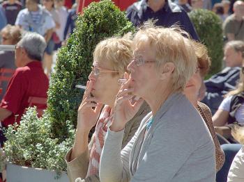 SHARING A PUFF: Two women have a smoke on Times Square on Wednesday. New legislation expanding the Smoke-Free Air Act of 2002 may soon include city parks and beaches. (Ben Kaminsky/The Epoch Times)