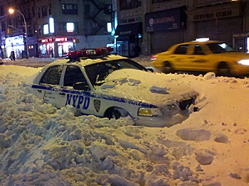 SHOVELS NEEDED: The blizzard might have passed but the snow remains, as this buried NYC police car clearly shows. (John Nania/The Epoch Times)