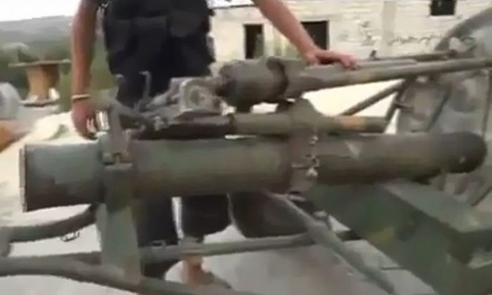 Grainy video footage uploaded to YouTube on Oct. 9 shows purported Syrian rebel fighters with captured army tanks and guns in Khirbet al-Jouz. On Friday, the Syrian Observatory for Human Rights said that 256 regime soldiers (not pictured) were captured. (YouTube.com)