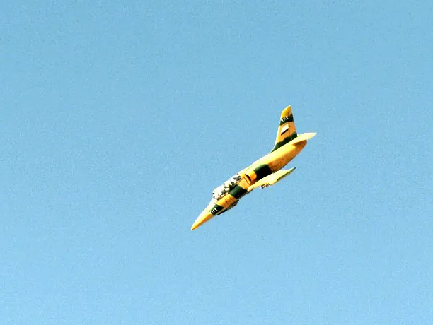 A Syrian army fighter jet flies over the northern city of Aleppo on October 13, 2012. Syria’s military has stepped up its use of the widely banned cluster bombs during battles against rebel forces. (Tauseef Mustafa/AFP/GettyImages)