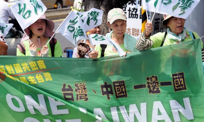 Anti-China demonstrators displays banners reading "one Taiwan, one China " in Taipei on August 8. Taiwanese have a poor impression of mainland Chinese people, the Chinese government, and its human rights record, according to a new survey. (Sam Yeh/AFP/Getty Images)
