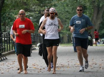 Tellman Knudson (center) begins his barefoot charity run across the United States.
