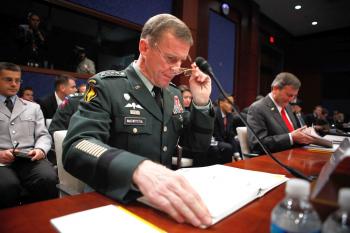 Commander of the International Security Assistance Force and Commander of U.S. Forces Afghanistan Gen. Stanley McChrystal (L) and U.S. Ambassador to Afghanistan Karl Eikenberry (R) read papers prior to a Dec. 8, hearing before the House Armed Services Com (Alex Wong/Getty Images)