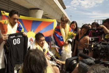 Cesar Maxit, (holding T-shirt), Kalaya'an Mendoza (seated), and Jonathan Stribling-Uss (Right) were interviewed by the press after they arrived JFK airport. The t-shirt held by Maxit is identical to the ones he, Mendoza, and Stribling-Uss displayed in t (Students for a Free Tibet ) Cesar Maxit, (holding T-shirt), Kalaya'an Mendoza (seated), and Jonathan Stribling-Uss (Right) were interviewed by the press after they arrived JFK airport. The t-shirt held by Maxit is identical to the ones he, Mendoza, and Stribling-Uss displayed in t (Students for a Free Tibet )