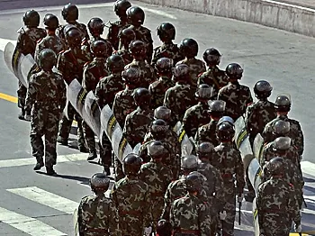 Residents look at Chinese soldiers as they patrol in Kangding county, the capital of Ganzi Tibetan Autonomous Prefecture, in China's southwestern Sichuan province on March 23, 2008.  (Teh Eng Koon/AFP/Getty Images)