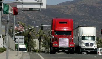Trucks on the highway in Otay Mesa, California. Trucking giant YRC Worldwide Inc. said that it has successfully staved off bankruptcy. (Sandy Huffaker/Getty Images)