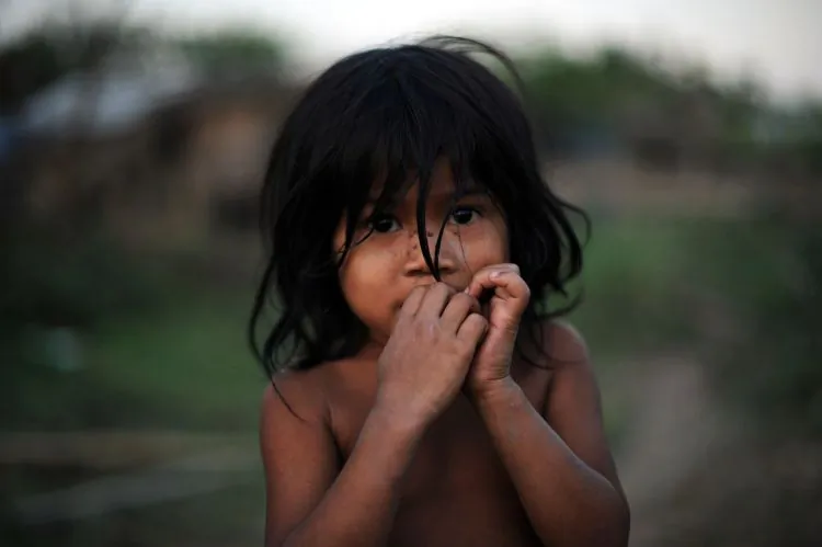 A child poses for a picture on the outskirts of Myanmar's biggest city Yangon on Feb.21 2011. (STR/AFP/Getty Images)