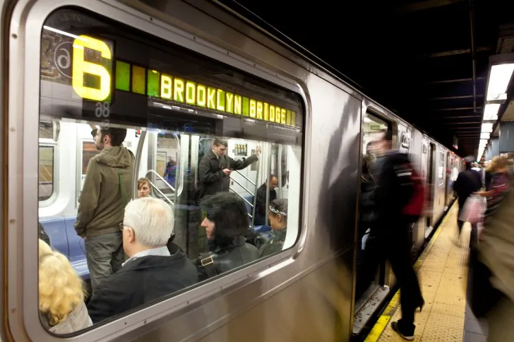 People board the number 6 train at the 86th street stop in New York City. (Amal Chen/The Epoch Times)