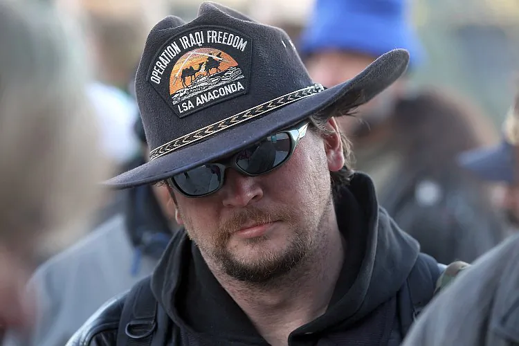 Homeless Iraq War veteran Patrick Dewitt waits in line to receive free services at an event hosted by the Department of Veterans Affairs on Nov. 3 in Denver, Colo. According to a report issued this month from the U.S. Congress Joint Economic Committee (JEC), poverty rates among post-9/11 veterans are nearly double the rates following other wars. (John Moore/Getty Images)