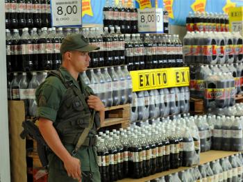 A member of the Venezuelan National Guard stands guard in one of the aisles at a supermarket on January 11, 2010 in Caracas.  (Juan Barreto/AFP/Getty Images)