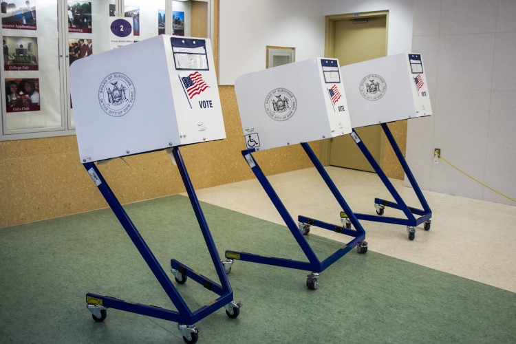Empty voting booths at a public school in the Financial District on Sept. 13. (Benjamin Chasteen/The Epoch Times)