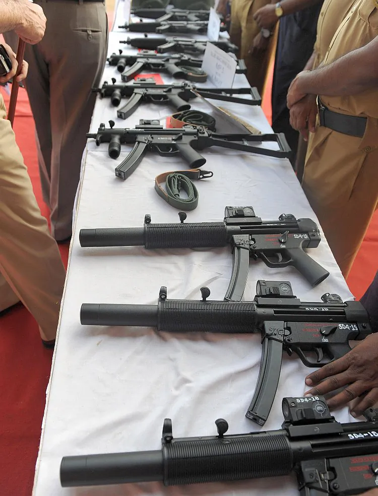 Indian policemen inspect various imported automatic weapons on display during a function to review the counterterrorism set up in Mumbai on Aug. 27, 2009. (Indranil Mukherjee/AFP/Getty Images)
