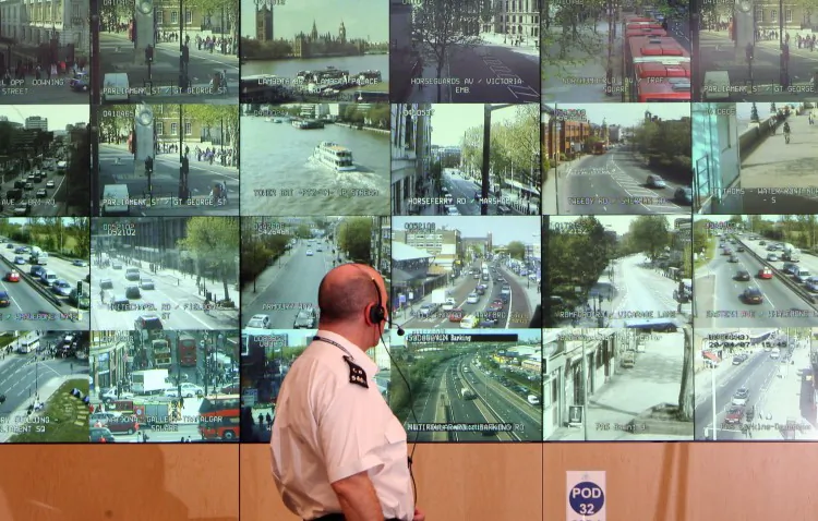 A police officer watches monitors showing a fraction of London's CCTV camera network in the Metropolitan Police's Special Operations Room on April 20, 2007 in London, England. The U.K. is set to give one of its intelligence agencies the right to survey communications without warrants. (Matt Cardy/Getty Images)