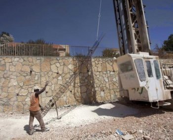 A worker prepares foundation for a new house on September 27, 2010 in the West Bank settlement of Kokhav Hashahar as Israel ended its 10-month settlement freeze in the West Bank. (Menahem Kahana/AFP/Getty Images)