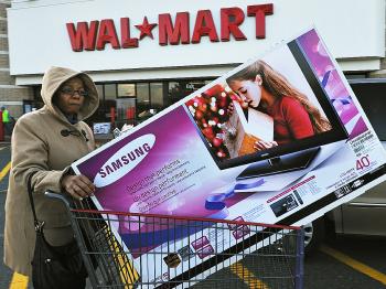 Holiday shoppers will be buying up large on the day after Christmas. Big retailers like Wal-Mart will be hoping that pockets are deep. (Paul J. Richards/AFP/Getty Images )
