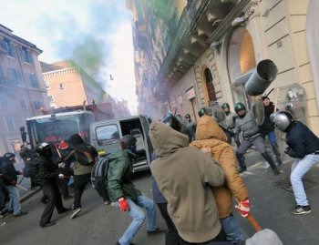 Youths face policemen during a protest to demand a change of government as Parliament met to hold a no confidence vote that left Prime Minister Silvio Berlusconi in office on Dec. 14 in Via del Corso in Rome. (Alberto Pizzoli/AFP/Getty Images)