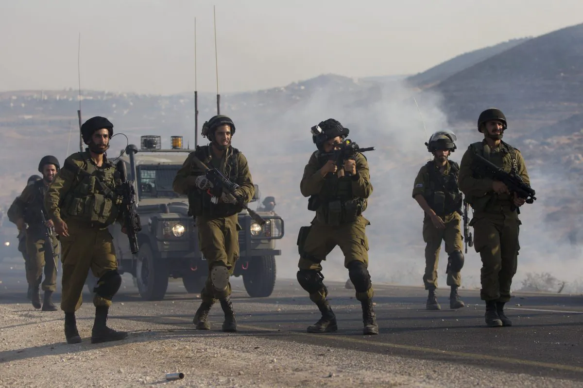 Israeli soldiers clash with Palestinians at the entrance of Duma village near the West Bank city of Nablus, Saturday, Aug. 1, 2015. (AP Photo/Majdi Mohammed)