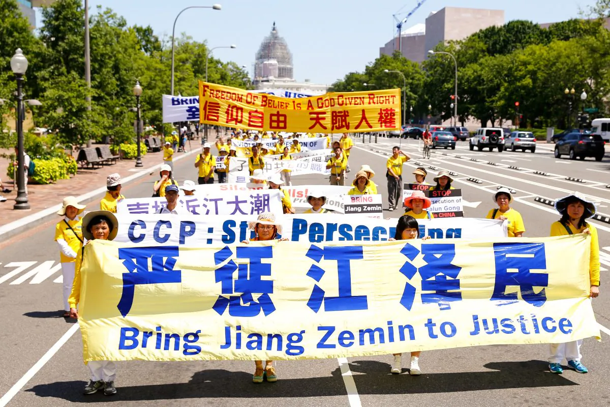 Falun Gong practitioners march in a parade in Washington calling for an end to the persecution that is now entering its 16 year inside China on July 16, 2015. (Edward Dye/Epoch Times)