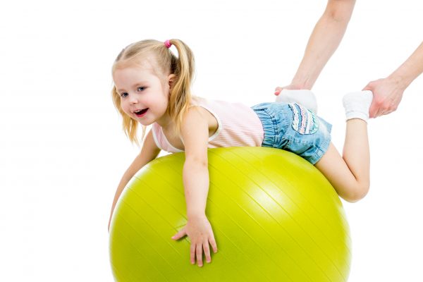 mother doing gymnastics with kid on fitness ball