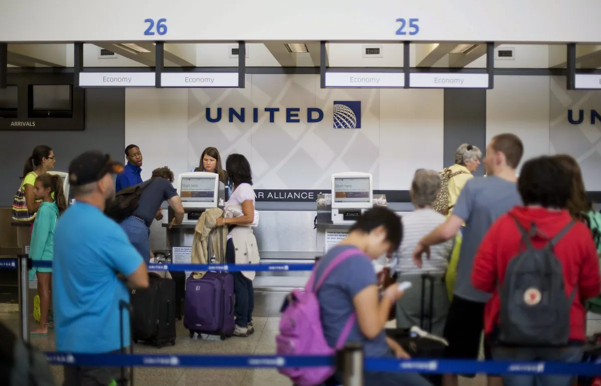 Travelers line up at a United Airlines check-in counter at HartsfieldJackson Atlanta International Airport Wednesday, July 8, 2015, in Atlanta. All United Continental flights in the U.S. were grounded Wednesday due to computer problems. Just shy of two hours after the problems began, the Federal Aviation Administration lifted the ground stop order.  (AP Photo/David Goldman)
