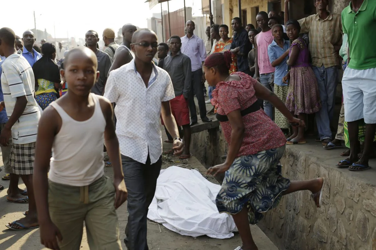The body of a man killed overnight is laid on a street as polls open for the presidential elections in Bujumbura, Burundi, Tuesday, July 21, 2015.(AP Photo/Jerome Delay)