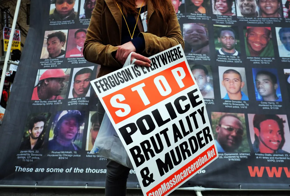 A protester displays a placard at the Union Square in New York on April 14, 2015 during a demonstration against the recent shooting death of Walter Scott by a South Carolina police officer. (Jewel Samad/AFP/Getty Images)