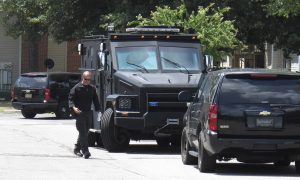 Manhunt Underway for Suspect in Officer's Fatal Shooting