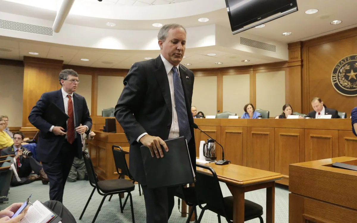 Texas attorney general Ken Paxton, right, with his chief of staff Bernie McNamee, left, departs after he testified during a Texas Texas Senate Health and Human Services Committee hearing on Planned Parenthood videos covertly recorded that target the abortion provider, Wednesday, July 29, 2015, in Austin, Texas. (AP Photo/Eric Gay)