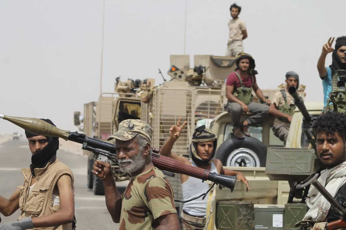 Fighters against Shiite rebels known as Houthis gather at the road leading to Al-Anad base near Aden in the southern province of Lahej, Yemen, on Aug. 3, 2015. (AP Photo/Wael Qubady)