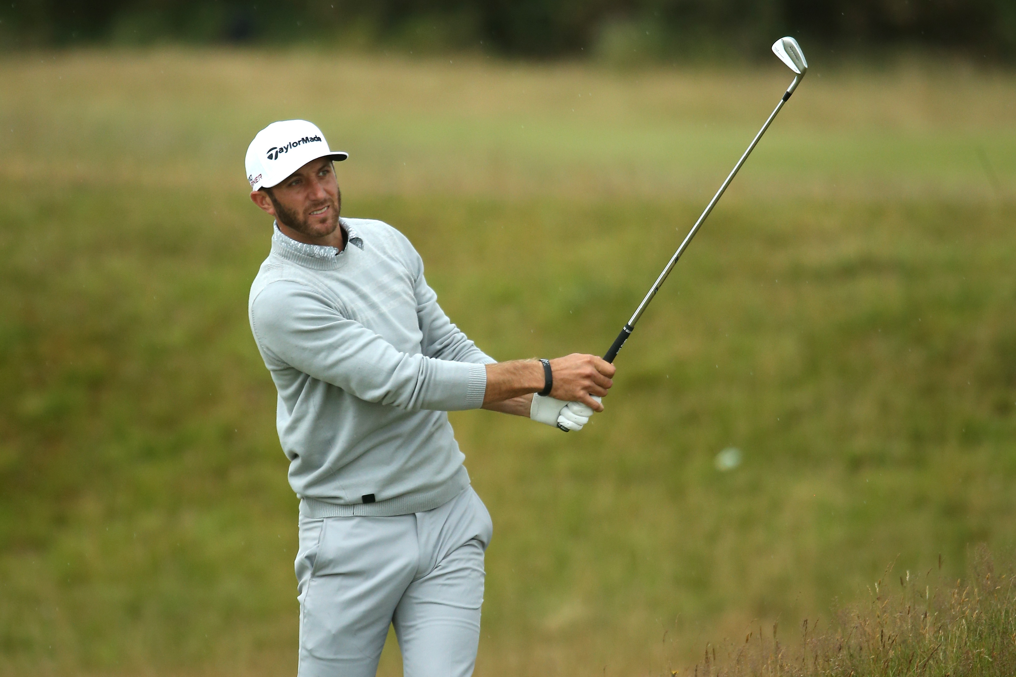 Dustin Johnson of the United States plays a shot from the 5th fairway durin...